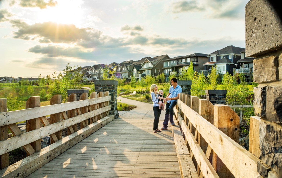 Couple with baby on wooden bridge that joins pathways